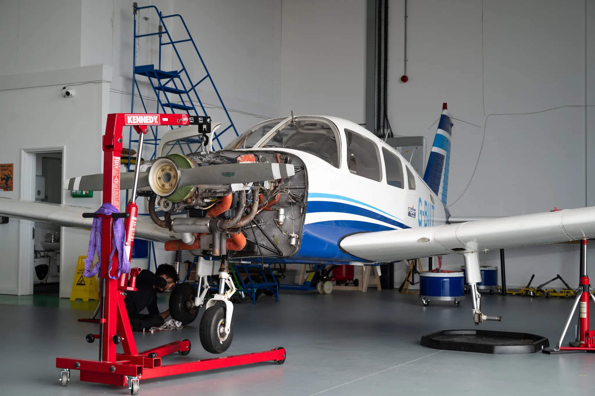A Piper PA-28 with its engine removed for maintenance