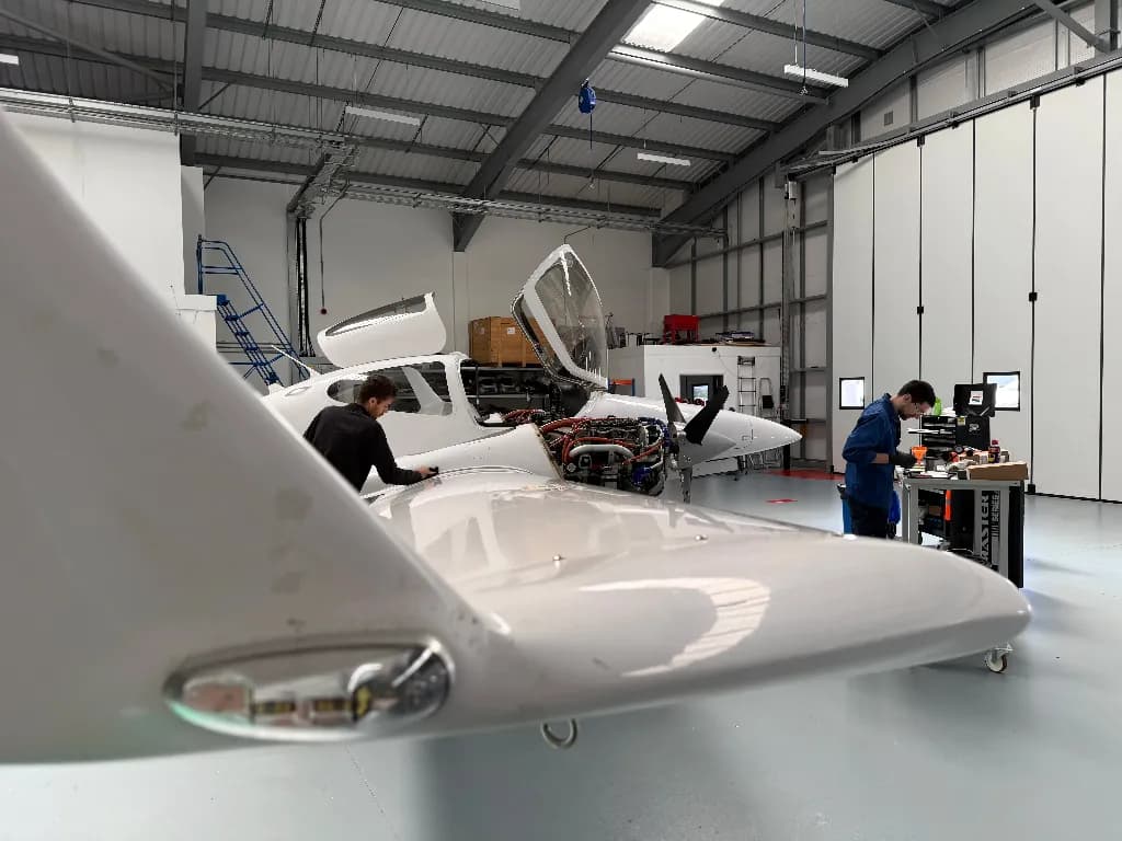 Engineers working on Diamond aircraft inside the hangar